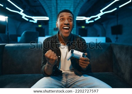 A player has won a console game. High quality photo Royalty-Free Stock Photo #2202727597