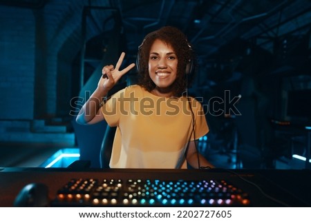 Girl cyber gamer plays computer game tournament. High quality photo