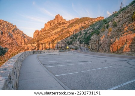 Mount Lemmon, Arizona- Scenic overlooking view of mountain landscape during sunset. Rest stop with parking spaces on the side of the road and mountain slope. Royalty-Free Stock Photo #2202731191