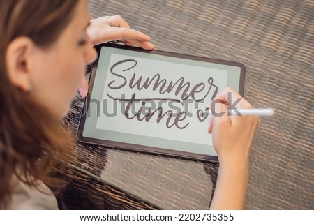 Calligrapher Young Woman writes phrase on digital tablet. Inscribing ornamental decorated letters. Calligraphy, graphic design, lettering, handwriting, creation Royalty-Free Stock Photo #2202735355