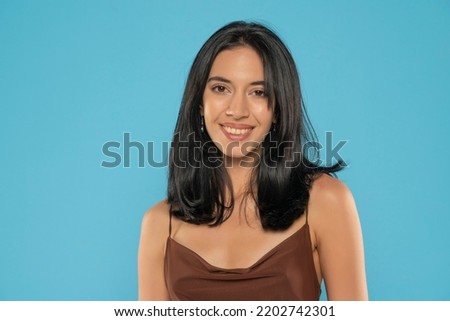 Portrait of yong positive woman , big smile, beautiful model posing in studio over blue background. Caucasian portrait woman. Royalty-Free Stock Photo #2202742301