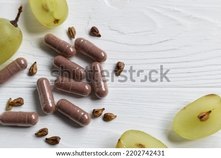 Dietary supplement with grape seed extract. Royalty-Free Stock Photo #2202742431