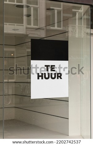 Sign 'Te huur' meaning 'For rent' on a window of an empty store facade placard. Retail shopping business exterior after closing down sale in The Netherlands, Europe crisis. Vertical shot
