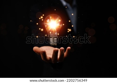 businessman holding a light bulb graphic Digital technology abstract. imagine an idea Creative and innovative. brain to brainstorm ideas in business. Strategies for development, growth, and success