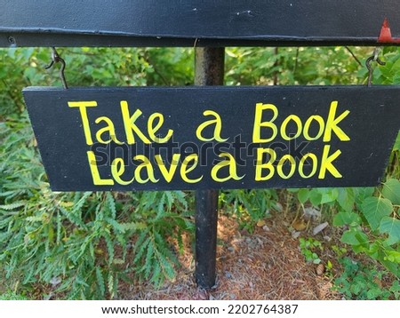 A handwritten sign saying for people to take a book and leave a book.