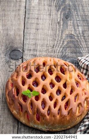 Delicious  fresh cherry pie on wooden table 