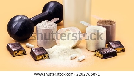 food supplements, whey, creatine, casein and whey, dumbbells, protein bar and pills for muscle mass gain Royalty-Free Stock Photo #2202766891