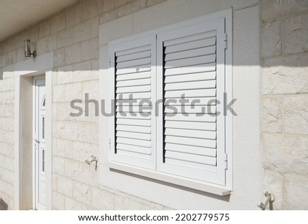 Plastic external window shutters for sun shade Royalty-Free Stock Photo #2202779575