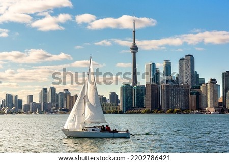 Panoramic view of Toronto skyline  and sail boat in a sunny day, Ontario, Canada