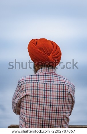 Back view of Indian man wearing Red Turban outdoor. Copy space for text, selective focus, travel photo, street view Royalty-Free Stock Photo #2202787867