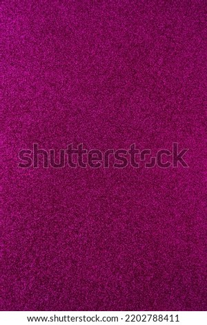 Background with sparkles. Backdrop with glitter. Shiny textured surface. Dark pink. Soft light
