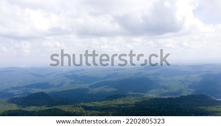 Mountain nature background, beautiful pictures of intricate mountains. Scenery with meadows and mountain peaks in the background on a sunny day.