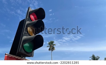 The traffic light with sky as background.
