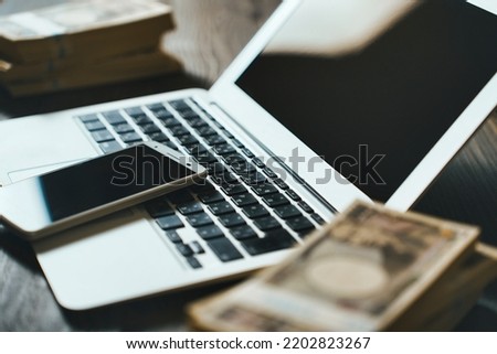 Japanese money and laptop background