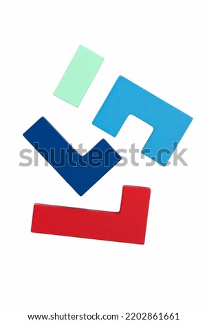 Different multicolored wooden blocks on a white background. Concept of logical thinking. 