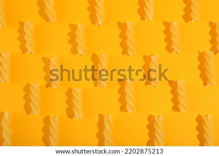 Flat lay with fusilli on orange background