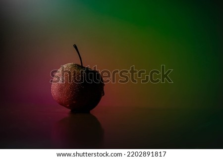 splash of water on Red apple on reflected wooden floor with Coloring background free stock Image  