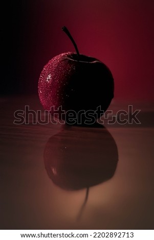 Splash of water Red apple on reflected wooden floor with Coloring background free stock Image 