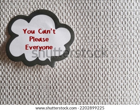 Word balloon stick on copy space background with handwritten text You Can’t Please Everyone - self reminder to stop trying to please everyone and be your authentic self Royalty-Free Stock Photo #2202899225