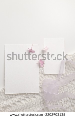 Mockup of a blank postcard with flowers next to it