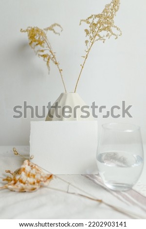 Mockup of an empty postcard on the background of a vase in the Scandinavian style