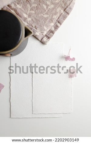 Mockup of a blank postcard with small flowers nearby