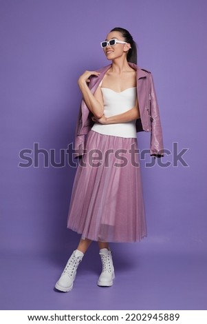 Fashion asian female model. Lilac leather jacket, lilac skirt, white boots, sunglasses. Asian fashion Royalty-Free Stock Photo #2202945889