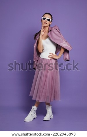 Fashion asian female model. Lilac leather jacket, lilac skirt, white boots, sunglasses. Asian fashion Royalty-Free Stock Photo #2202945893