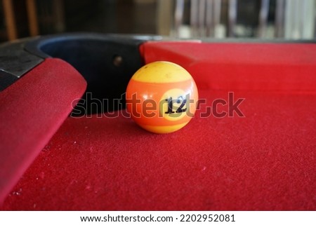 billiard balls on a red table