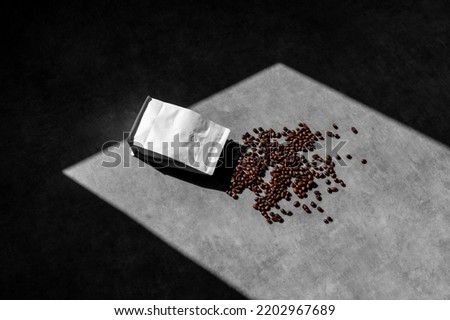 Open blank packaging doy pack coffee mockup, on concrete background, with coffee beans, sharp natural sunlit shadows. Packaging mockup template with empty space to display your branding design.shalf