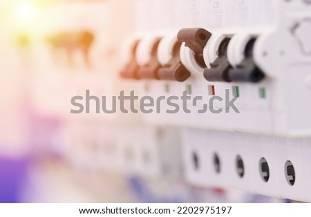  circuit breakers for protection of electrical loads installed in the electrical panel. Soft focus. Royalty-Free Stock Photo #2202975197