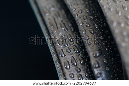 Water droplets on the rubber membrane. Waterproofing...  Close-up selective focus area. Royalty-Free Stock Photo #2202994697