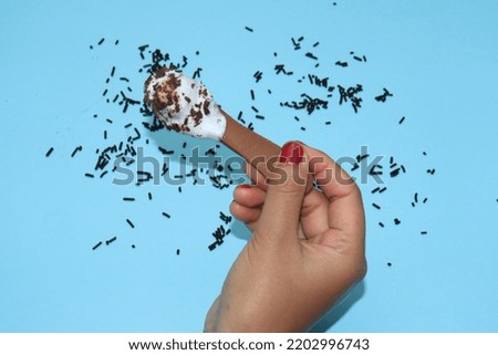 woman's hand with ice cream and spoon
