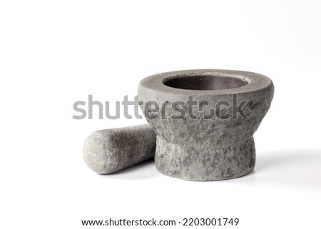Mortar and Pestle isolated on white background.mortar is a tool for finely grinding herbs in Asian cuisine.handmade stone mortar.Old stone mortar that has been used for a long time. Royalty-Free Stock Photo #2203001749