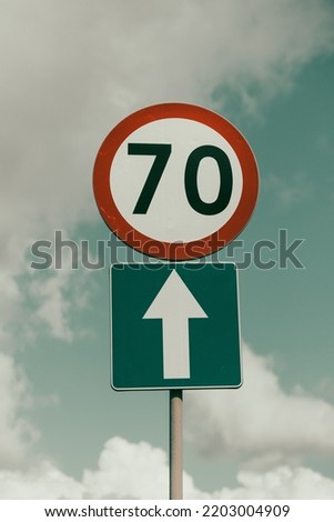 Speed sign showing 70 and a arrow. 