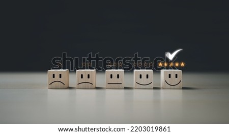 Questionnaire best excellent business services rating customer experience. Chooses a smiley face on wood block cube. Satisfaction survey. Give five Star good comparison. Royalty-Free Stock Photo #2203019861