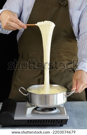Pommes Aligot, Stretchy dish mixed with cheese (Tomme fraîche de l'Aubrac)  and mashed potatoes, traditional french cuisine Royalty-Free Stock Photo #2203074679