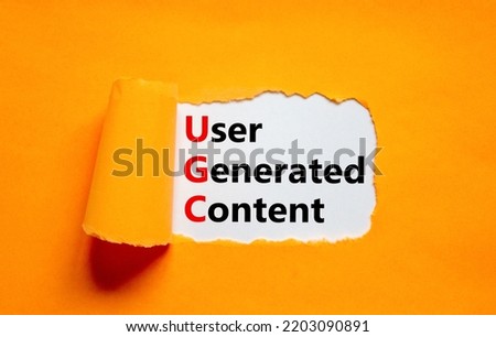 UGC user generated content symbol. Concept words UGC user generated content on white paper on a beautiful orange background. Business and UGC user generated content concept. Copy space. Royalty-Free Stock Photo #2203090891