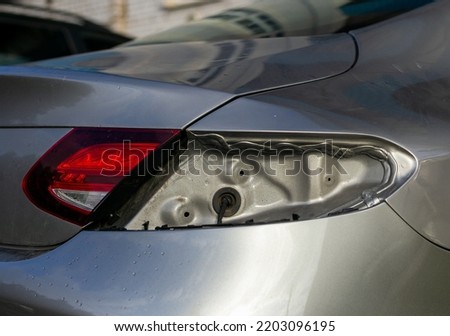 Luxury silver sedan with no rear brake light.  There is no taillight on the car close-up. Royalty-Free Stock Photo #2203096195