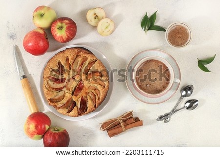 Cozy home table with apple pie and cappuccino coffee, honey, apples,healthy breakfast with ingredients concept hello autumn, hygge style, modern bakery advertisement, selective focus,