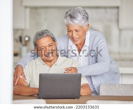 Retirement, laptop and senior couple on the internet reading an email or news via a social network website. Happy elderly woman with a relaxed husband streaming or browsing online at home Royalty-Free Stock Photo #2203133631