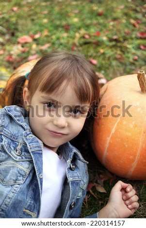 Autumn photo of a young girl with pumpkins