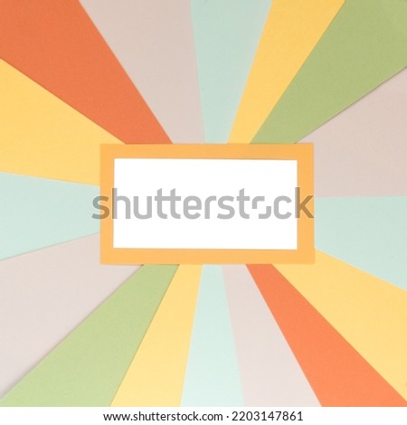 Template of empty white label with vintage sunburst background made with stripes of colored paper