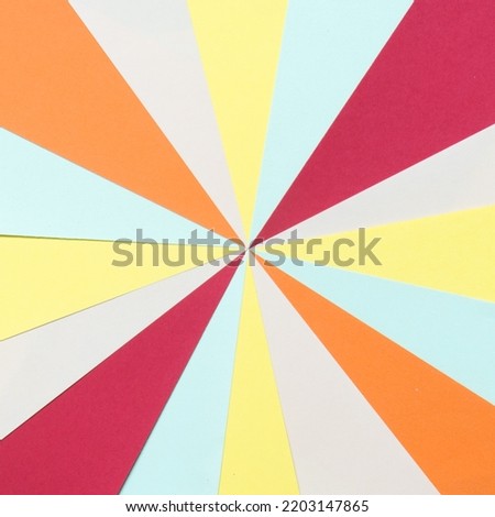 Retro sunburst background made with stripes of colored paper