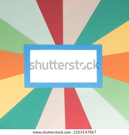 Template of blank white label with retro sunburst background made with stripes of colored paper