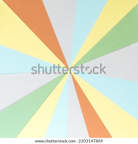 Vintage sunburst background made with stripes of colored paper