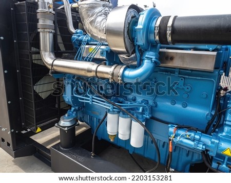 Marine diesel engine. Fragment of ships engine. Motor ship close-up. Ship equipment. New open-air marine engine. Concept of construction and repair of river vessels. Shipbuilding industry Royalty-Free Stock Photo #2203153281