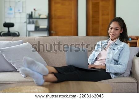 Portrait of a black person using a computer at home