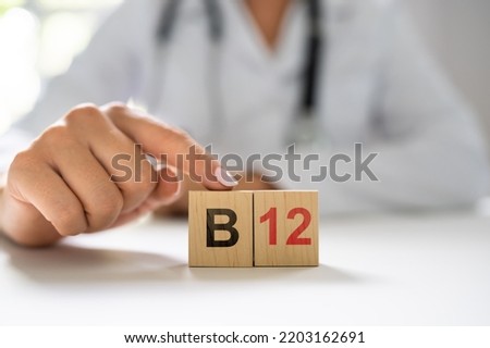 Vitamin B12. Medical Doctor Hand In Hospital Royalty-Free Stock Photo #2203162691