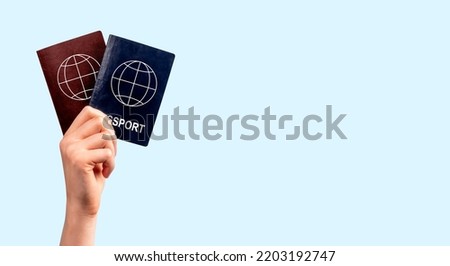 Two different passports in hand. Banner with copy space.